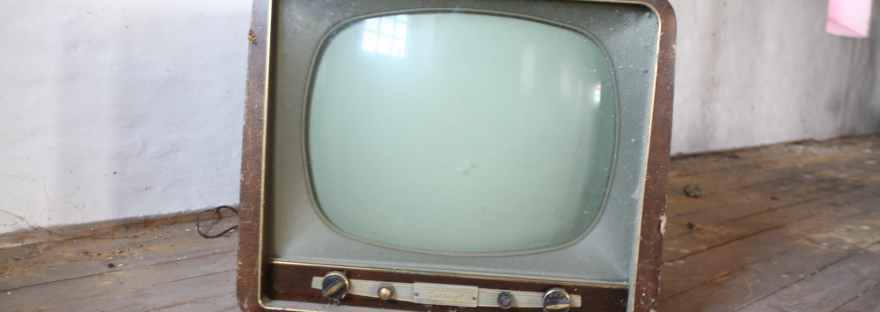 vintage brown crt tv on parquet wood flooring