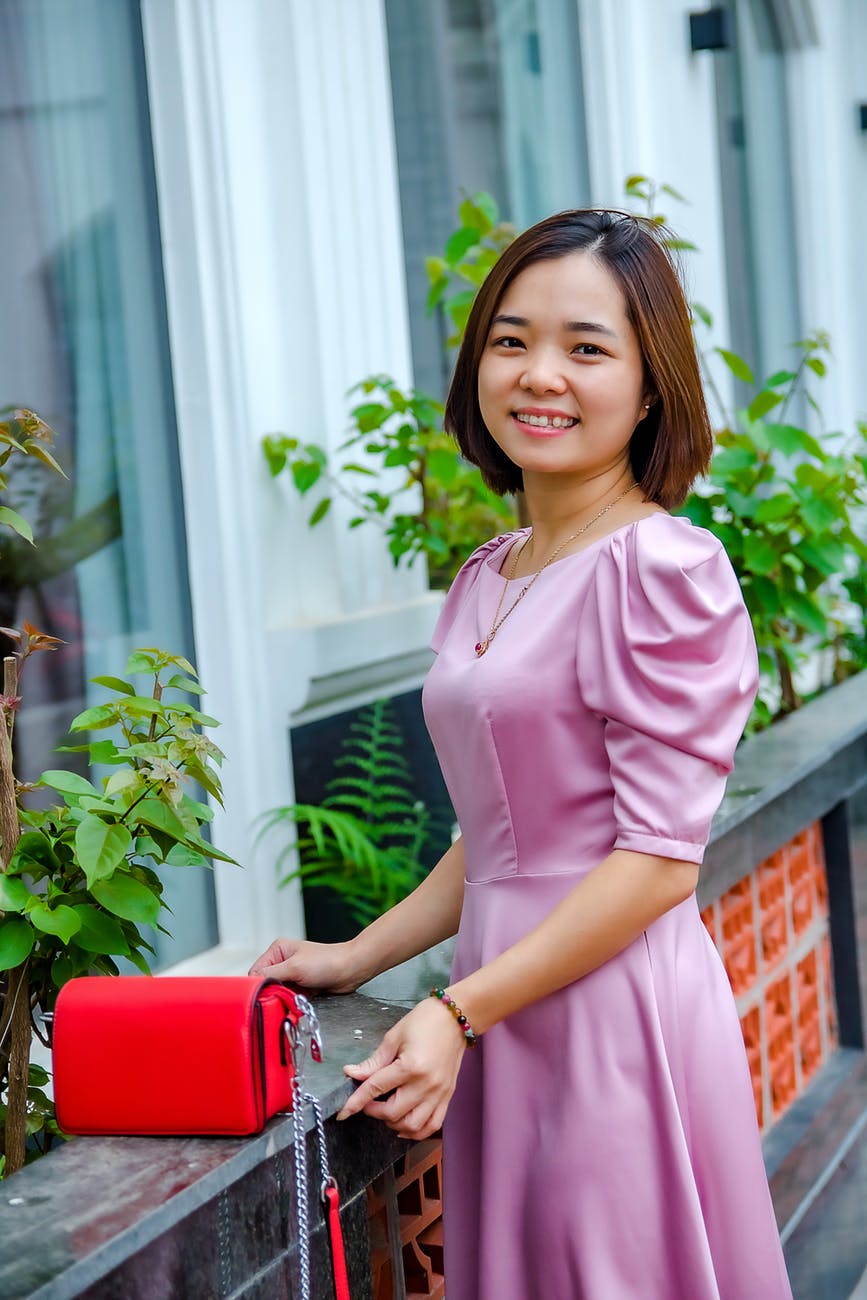 woman in purple dress smiling